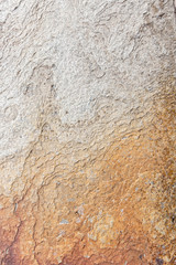 Textured flat light brown and grey rock surface