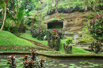 Fototapeta na wymiar Goa Gajah Hidden Lush Green Forest With Caves, Secret Waterfalls and Ancient Carvings In Bali, Indonesia
