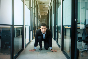 Asian businessman preparing to run on the hallway