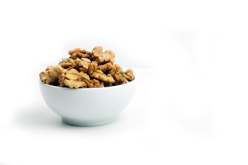 a bowl of peeled walnut isolated on white background