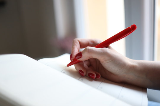 Female Young Hands Write Down Goals Or Plans Or Tasks In A Notebook 