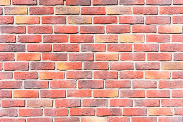 Red and yellow brick wall background. Texture suitable for background. Pattern of colored bricks