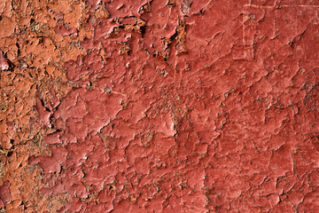 Cracked red paint with rust. Seamless old texture background