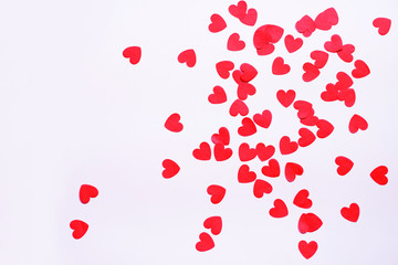 festive background with paper decorations in the form of heart on white surface