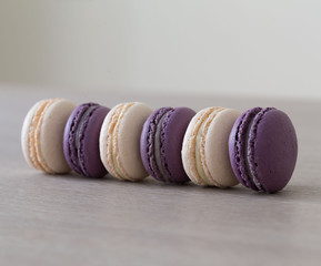 Food. macaroons white and purple, beige background