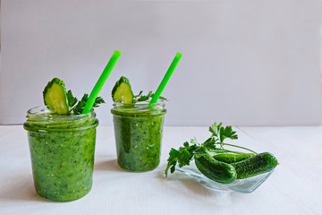 Green cocktail of spinach, lemon, cucumber and parsley on a light background. The concept of healthy nutrition, detox, green, diet, vegan, keto, fit