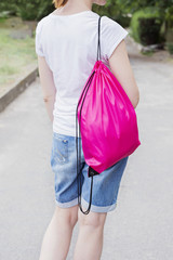 Woman with drawstring bag on the shoulder.