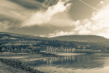 Obraz premium Looking over the Village Fairlie with the development of new houses set above the village. Image has an old Black & White feel
