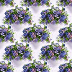 Seamless background with a bouquet of spring flowers on a background of water drops.