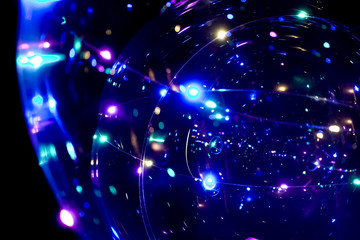 Colored lights in the form of a sphere on a dark background. Abstract dark background. Space emulation