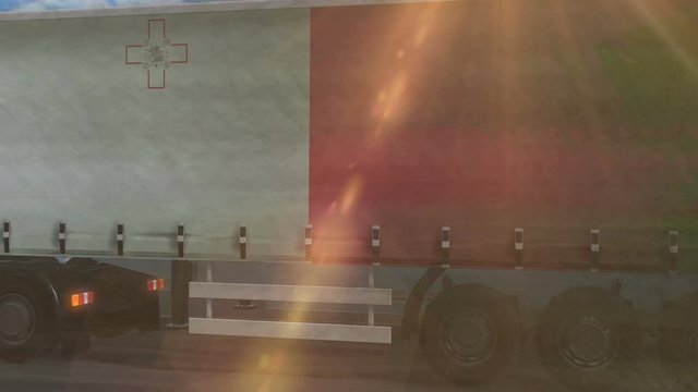 Malta flag shown on the side of a large truck driving on a highway