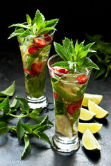 Summer  cold drink (juice, cocktail, fruit tea) with berries, selective focus