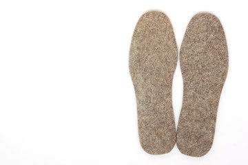 two felt insoles on a white background.