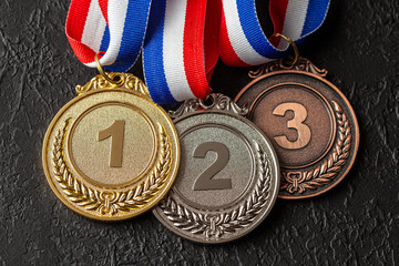Gold, silver and bronze medal with ribbons. Award for first, second and third place in the...