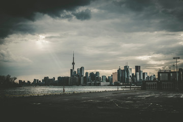 A high-contrast view of the Toronto skyline with a dramatic sky covered in clouds, Toronto,...