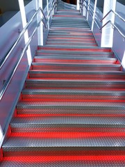 Fototapeta premium Close-up of abstract metal staircase with backlight with blur / side effect. Background for postcards, wallpapers, savers