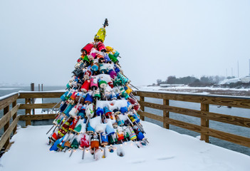 Christmas tree buoys, lights, and snow in Wells, Maine.