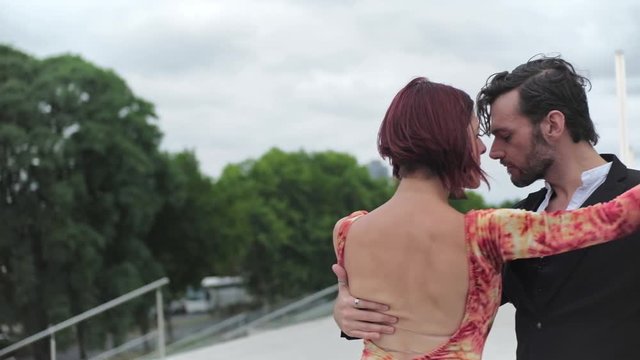 Parallax shot of two tango dancers dancing on iconic places of Buenos Aires. SLOW MOTION