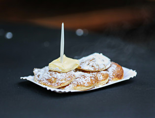 Poffertjes mini pancakes being cooked and served in Amsterdam.