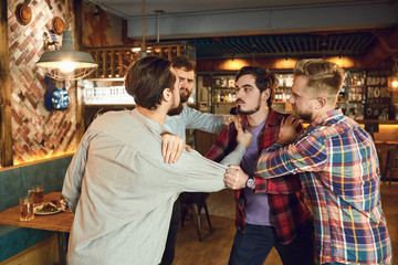 Men fight in a pub bar.