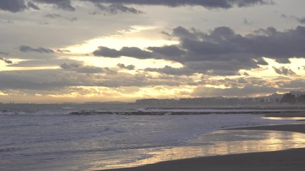 Golden sunset with the waves caressing the coast gently