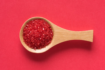 Red Confectionery Sugar on a Spoon