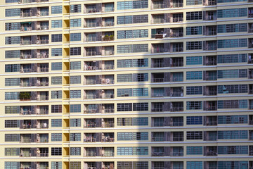 Fototapeta na wymiar Old apartment building with many windows and balconies.