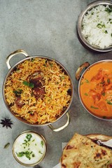 Indian meal menu - Goat Biryani Butter chicken Naan background