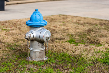 Fototapeta na wymiar Colorful Blue and Silver Fire Hydrant used for supplying high volume of water