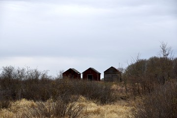 three old buildings on a hill