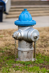 Fototapeta na wymiar Colorful Blue and Silver Fire Hydrant used for supplying high volume of water