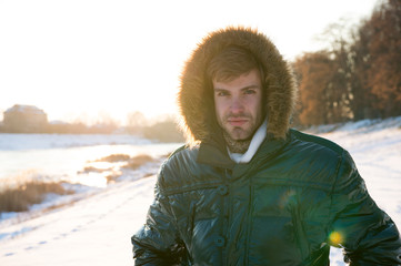 Concept ecology. male in down coat with fur hood. feel warm and comfortable. favorite season....