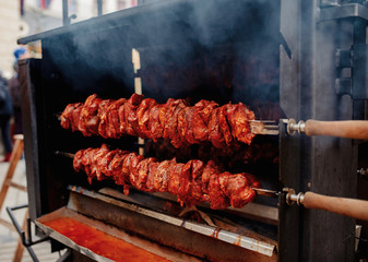 pork meat on a sword in a Christmas market
