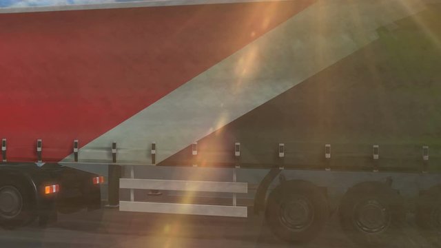 Sealand Principality flag shown on the side of a large truck driving on a highway