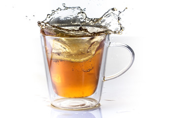 Tea with lemon in a glass thermo cup on a white background.