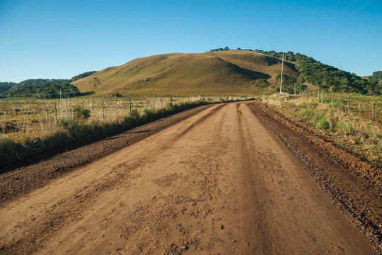Deserted dirt road passing through rural lowlands