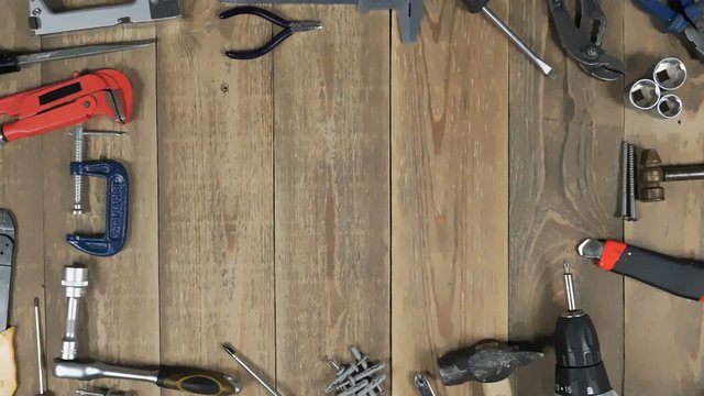 Animation of various tool to promote home craftsman on wooden background. Theme stop motion hand tools for logo intro. Concept of brand promotion for provision of repair locksmith or woodworker.