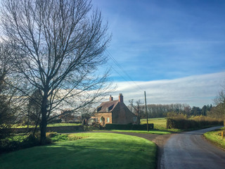 Cottage in English countryside in spring, quaint and beautiful in the early morning