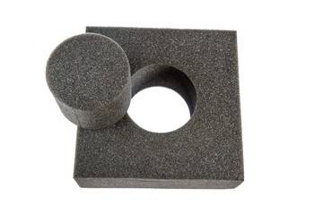 Black sponge foam in a shape of electronic or computer part, a protective equipment on white...