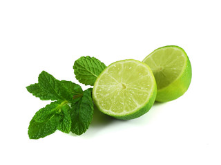Sprig of fresh mint and halved lime isolated on white background. Natural ingredients for mojito and herbal tea. 