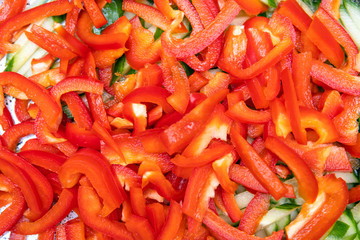 chopped red bell pepper and cucumbers, background