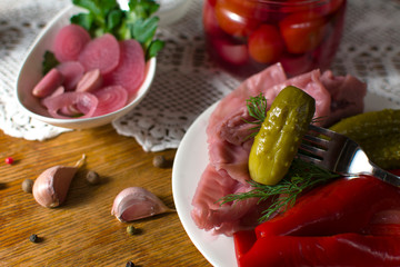 Different types of pickled vegetables. Pickled cucumbers, tomato, cabbage, pepper, greens, onion and garlic served on old style table with handmade tablecloth. Homemade fermented vegetables. Top wiev