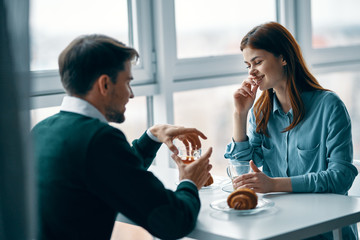 young couple having breakfast in cafe