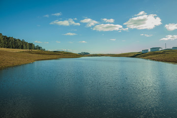 Blue lake on landscape of rural lowlands