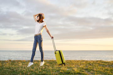 woman with suitcase on the road