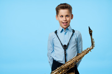 Boy musician plays the saxophone