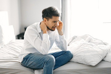 young man sitting on sofa at home