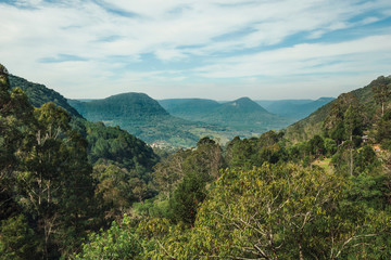 Landscape of valley with hills covered by forests