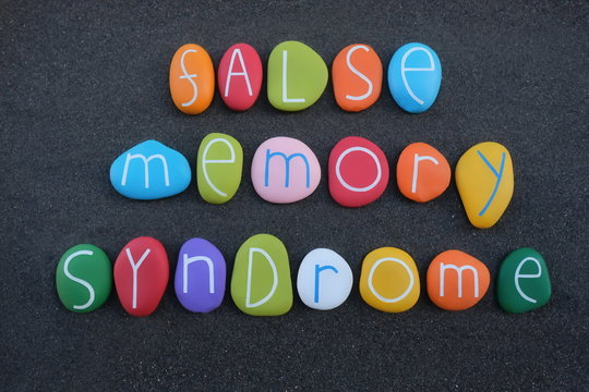 False Memory Syndrome Text Composed With Creative Painted Stone Letters Over Black Volcanic Sand