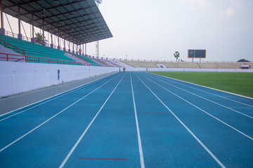 Running track in a rural stadium. People running exercise faces blurred. Which cannot recognize faces.